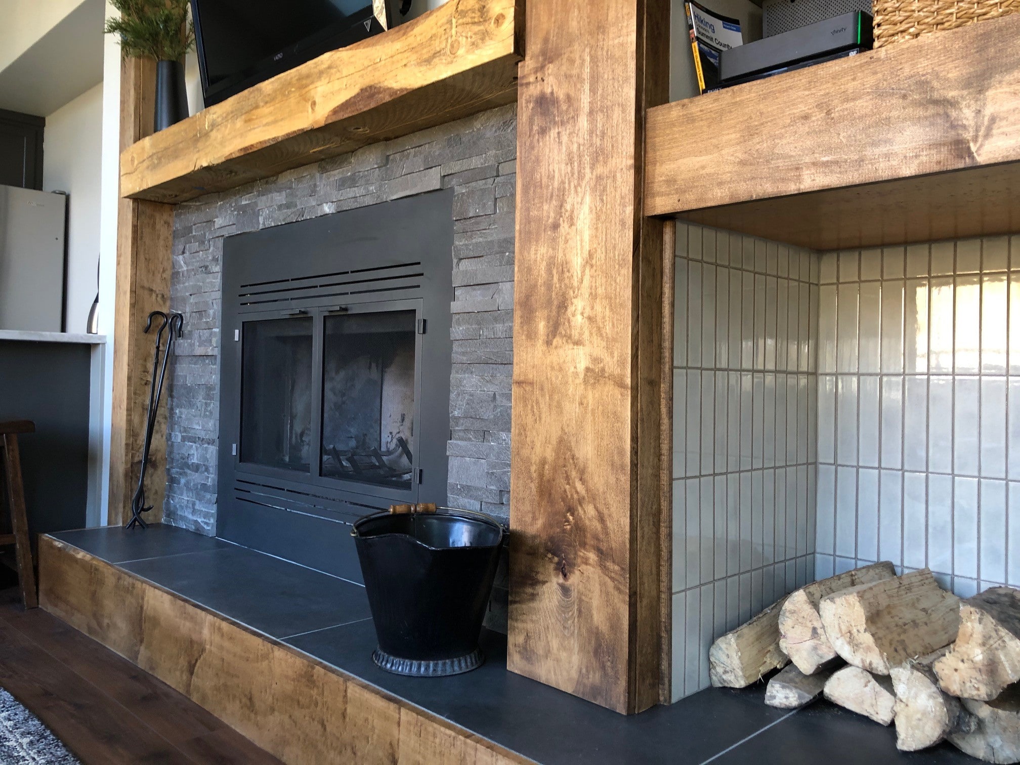 Norstone Charcoal Rock Panels surrounding black metal fireplace insert in Colorado mountain ski condo